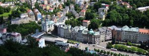 Karlovy Vary town. There is main streen with old houses and a church.