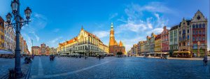 Wroclaw town square. There are traditional houses, in the background there is town hall